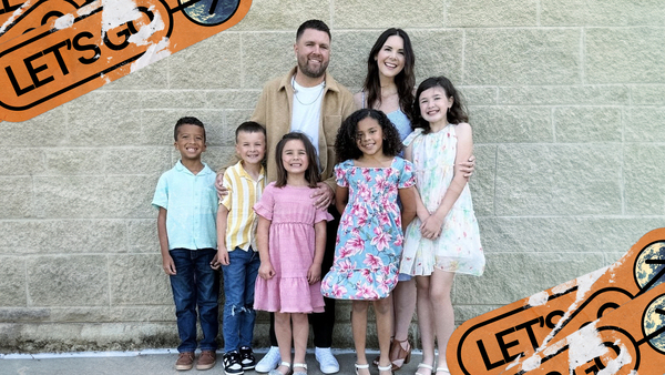 The Benjamin family poses together and smiles.