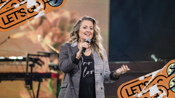 Amy Ford speaks into a microphone on a stage
