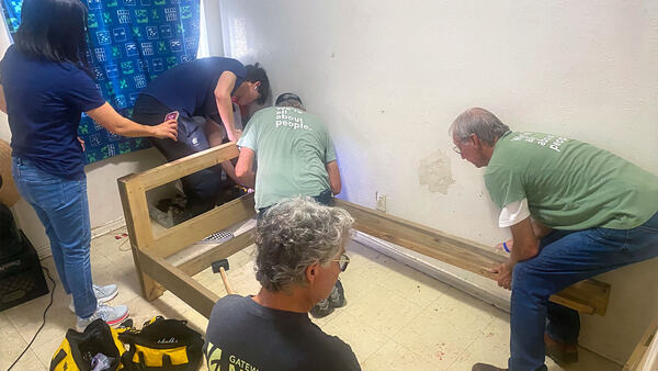 Volunteers assemble a free bed for child who previously had to sleep on the floor.